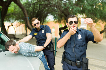 Poster - Policeman looking at the drug evidence after an arrest