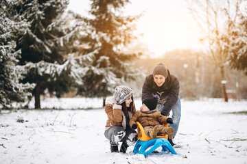  Family with little son on a sleigh ride