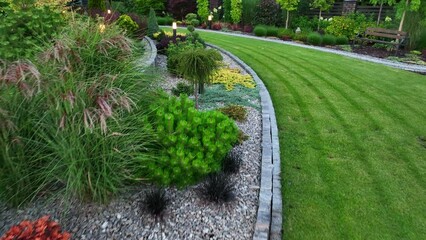 residential rockery backyard garden led outdoor light illumination. night time scenery.