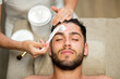 canvas print picture - Cosmetician doing purifying face treatment for man