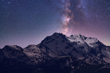 Wall Mural - night landscape. beautiful snow covered mountains in the starry night with milky way galaxy.