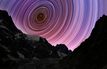 Wall Mural - beautiful night landscape. high mountains in the starry night with star tracks. long exposure night 