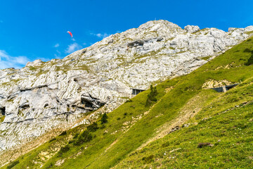 Wall Mural - Pink Parasail Rock Cliffs Pastures Climbing Mount Pilatus Lucerne Switzerland