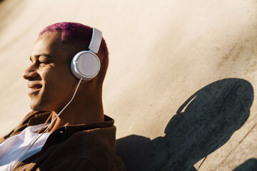 Cropped portrait of young handsome smiling boy in headphones