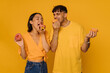 © Drobot Dean - Young asian woman and man eating donuts with closed eyes