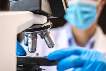 Wall Mural - biotechnology scientist using scientific microscope for research in biology medicine laboratory, equ