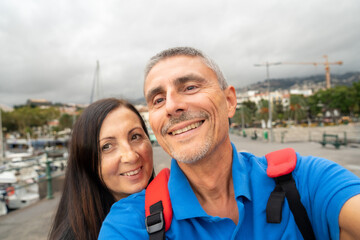 Poster - Happy couple taking selfies in a beautiful island small port