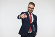 attractive young man with glasses pointing finger and smiling