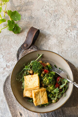 Wall Mural - bowl of fried tofu with broccoli on the table