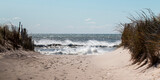 Fototapeta Perspektywa 3d - View of walking down the beach with a rough Atlantic Ocean