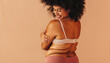 Self-loving plus size woman embracing her natural body