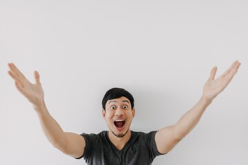 Wall Mural - Wow surprise shock face Asian man in black t-shirt isolated on white background.