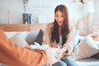 © oatawa - Excited asian woman getting surprise gift from her girlfriend at home. Gives a gift.