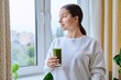 © Valerii Honcharuk - Teenage girl with glass of green fresh in morning at home near window