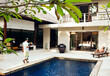 © Matthew Wakem - Woman relaxing by pool at a private pool villa, Bali, Indonesia.