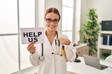 Sticker - Young caucasian woman wearing doctor uniform holding help us banner pointing finger to one self smiling happy and proud