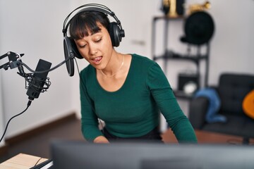 Sticker - Young beautiful hispanic woman musician singing song playing piano at music studio