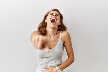 Canvas Print - Beautiful caucasian woman standing over isolated background laughing at you, pointing finger to the camera with hand over body, shame expression