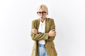 Canvas Print - Beautiful caucasian business woman standing over isolated background shaking and freezing for winter cold with sad and shock expression on face