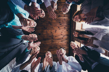 Wall Mural - Low angle below view portrait of attractive cheerful people specialists clapping palms support at loft industrial interior indoors