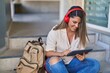 © Krakenimages.com - Young hispanic woman student smiling confident watching video on touchpad at university