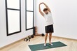 © Krakenimages.com - Young arab man smiling confident stretching at sport center