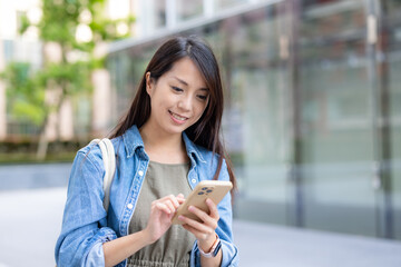 Wall Mural - Woman use mobile phone in city at street