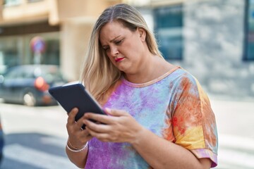 Sticker - Young woman using touchpad with serious expression at street