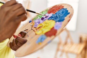 Poster - African american artist woman mixing color on palette at art studio.