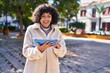 © Krakenimages.com - Young beautiful hispanic woman smiling confident watching video on touchpad at park