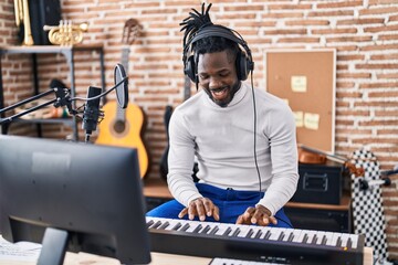 Sticker - African american woman musician playing piano keyboard at music studio