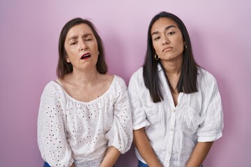 Poster - Hispanic mother and daughter together looking sleepy and tired, exhausted for fatigue and hangover, lazy eyes in the morning.