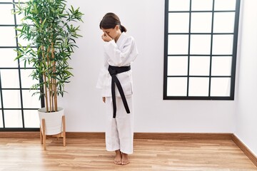 Sticker - Young hispanic girl wearing karate kimono and black belt tired rubbing nose and eyes feeling fatigue and headache. stress and frustration concept.