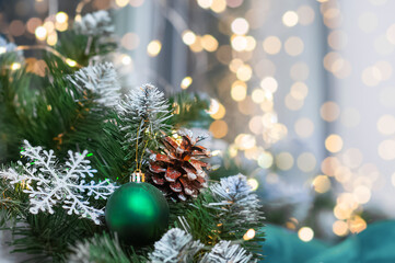  Fir branch with New Year's toy closeup and copy space. Christmas tree in interior in defocus