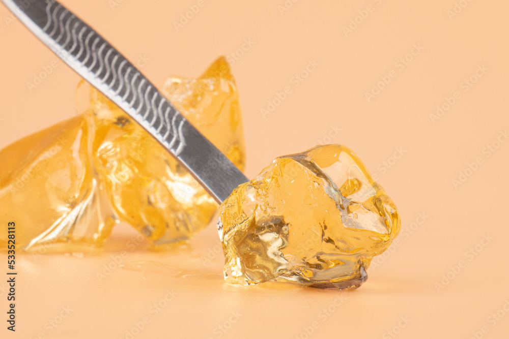yellow wax with dabbing stick of cannabis resin for smoking high in THC