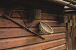 Old peasant tools hanging on wooden wall on animal farm.