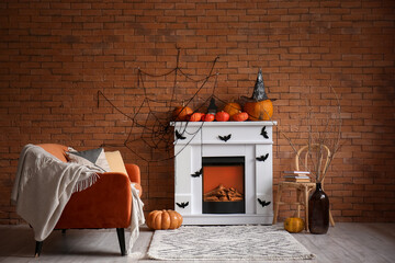 Interior of living room decorated for Halloween with fireplace, sofa and chair