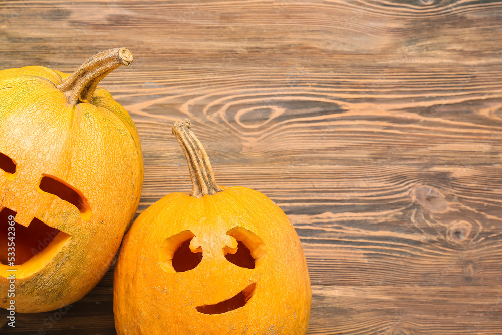 Carved Halloween pumpkins on wooden background