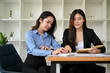 © bongkarn - Attractive Asian female accountants working together in the office