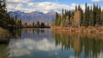 Wall Mural - picturesque autumn landscape with reflection of clouds, mountains and yellowed forest in calm blue w