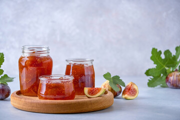 Wall Mural - Fig jam in a glass jar and bowl. Fruits preserve