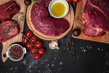 Poster - beef meat background fillet steaks with herbs and spices on a dark background. Restaurant menu, dieting, cookbook recipe top view