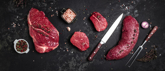 Poster - Whole piece of tenderloin with steaks and spices ready to cook, Long banner format. top view