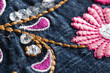 Children's denim suit with embroidered patterns, macro, background