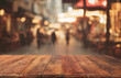 Empty wood table top on blur abstract of street restaurant outdoor night city background, for montage product display, 3d rendering