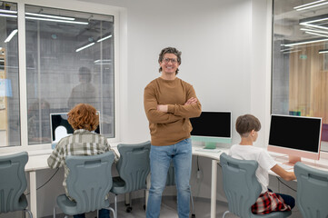 teacher supervising school boys during the test at the lesson
