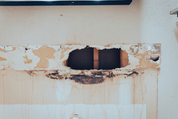 Toned photo broken drywall in bathroom with water damaged, mold, mildew on surface of residential house in Texas, US