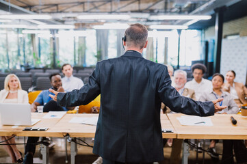 Cinematic image of a conference meeting. Business people sitting in a room listening to the motivator coach. Representation of a Self growth and improvement special event