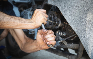 Wall Mural - Mechanic repairing engine of motorcycle. Concept of motorcycle maintenance