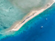 High angle aerial drone view of Langford Island's sandspit or sandbar, a small islet near Hayman Island in the Whitsunday Islands group near the Great Barrier Reef in Queensland, Australia.